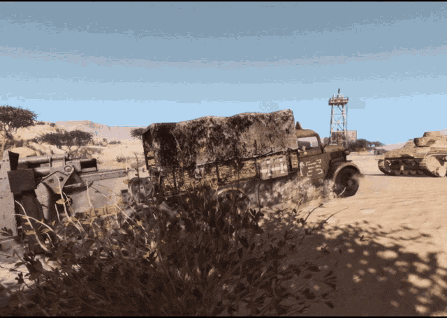a truck with a large rock on the back is driving through the desert