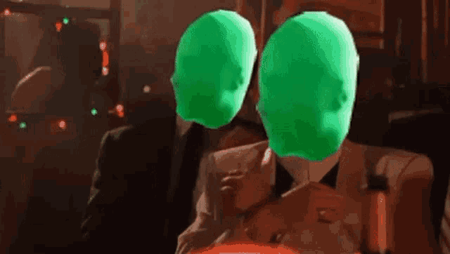 two green heads are sitting next to each other .