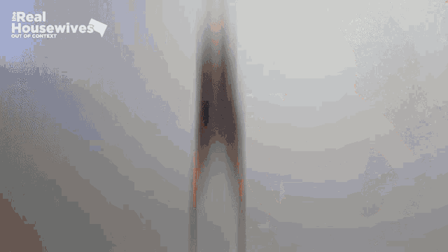a blurred image of a woman with the words real housewives out of context behind her