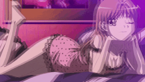 a girl in polka dot pajamas is laying on a bed with her legs crossed