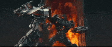 a robot is burning in a fire with a sword