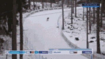 a blurred image of a person riding a sled down a snowy track