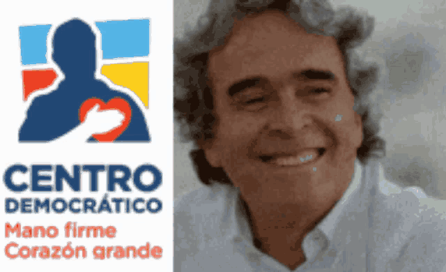 a man is smiling in front of a logo for centro democrático
