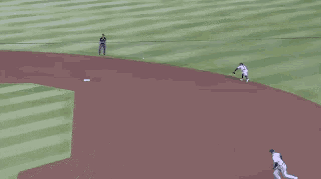a group of baseball players are playing a game of baseball on a baseball field .