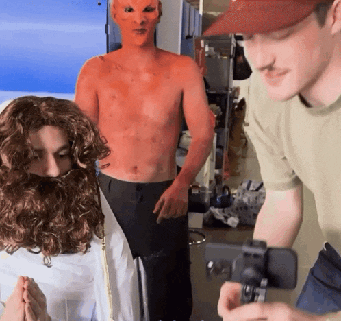 a man wearing a red mask is standing next to another man
