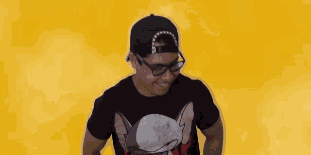 a man wearing a black t-shirt that says rick and morty