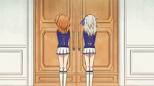 two girls are standing in front of a door that says " tokyo " on it