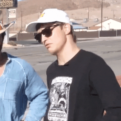 a man wearing sunglasses and a t-shirt that says nirvanas