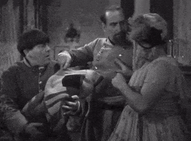 a black and white photo of a baby sleeping on a bed