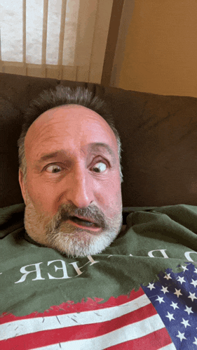 a man with a beard is wearing a green shirt that says " a3v "