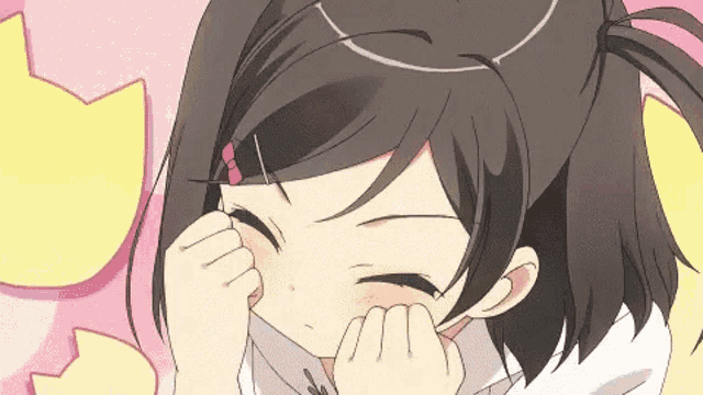 a girl with a ponytail is covering her face with her hand