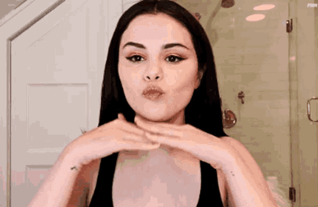 a woman with a tattoo on her wrist is making a face
