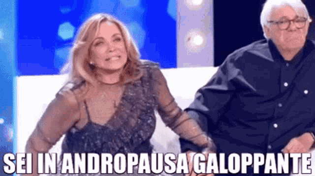 a man and a woman are standing next to each other with the words sei in andropausa galoppante written on the bottom