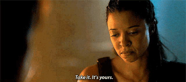 a woman is talking to another woman and saying take it , it 's yours .