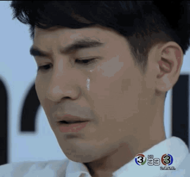a close up of a man 's face with a tear coming out of his eye and the number 3 on the bottom right