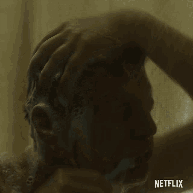 a man taking a shower with netflix written on the bottom right