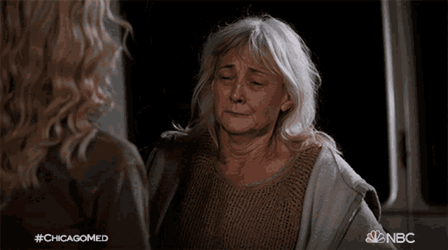 an older woman is being comforted by a younger woman in a nbc ad