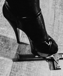 a black and white photo of a woman 's foot standing on a lighter