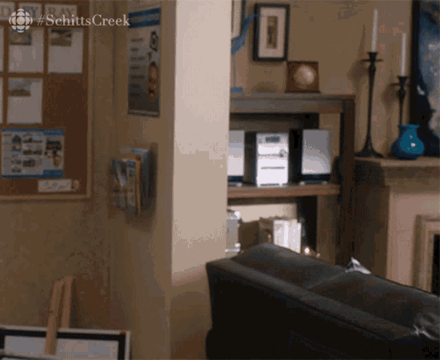 a living room with a sign that says schittscreek on it
