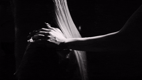 a black and white photo of a person 's feet on a wooden floor