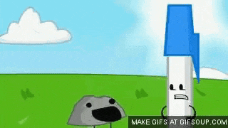 a pen and a rock are standing next to each other in a grassy field .
