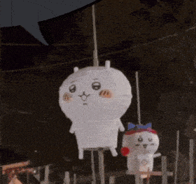 a stuffed animal is hanging from a rope with another stuffed animal in the background
