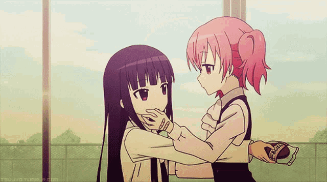 two anime girls are hugging each other and one of them is holding a bag of candy