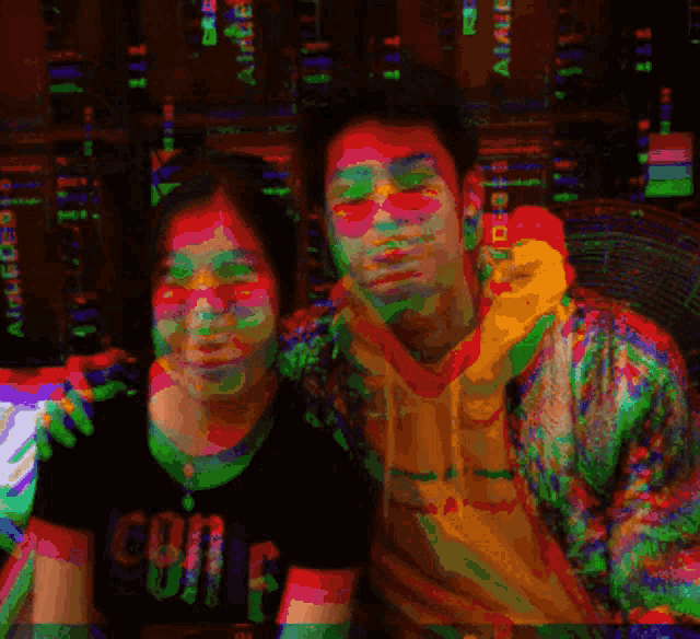 a man and a woman are posing for a picture and the woman is wearing a shirt that says " coin "