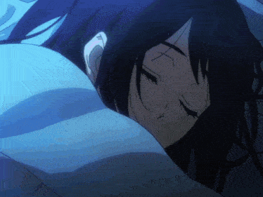 a girl with long black hair is sleeping in a bed