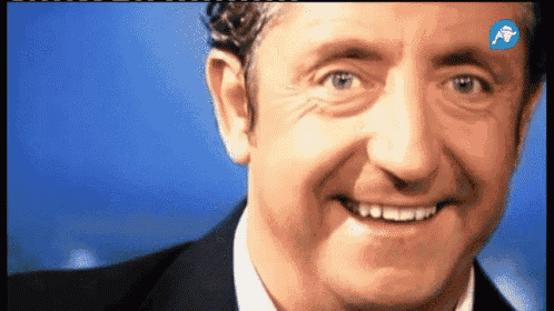 a close up of a man 's face with a blue background and a blue arrow pointing to the left