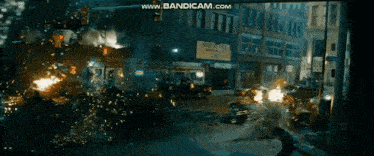 a busy city street with cars on fire and a building that says maggie 's pizza