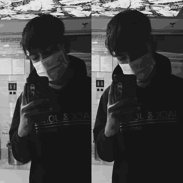 a man wearing a face mask is taking a selfie