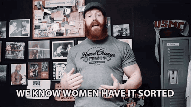 a man with a beard wearing a brave change gymnasium shirt
