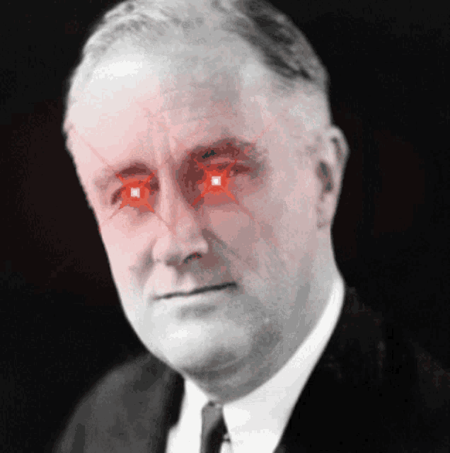 a close up of a man 's face with red lights coming out of his eyes