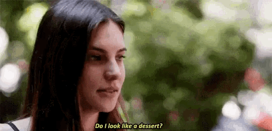 a woman is talking to a man and asking him if he looks like a dessert .