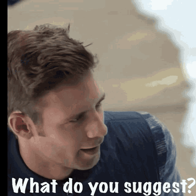 a man in a blue shirt with the words what do you suggest above him