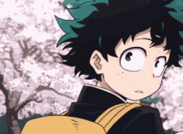 a young boy with green hair and a yellow backpack is standing in front of a cherry blossom tree .