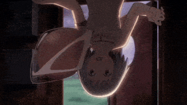 a girl is hanging upside down in a room