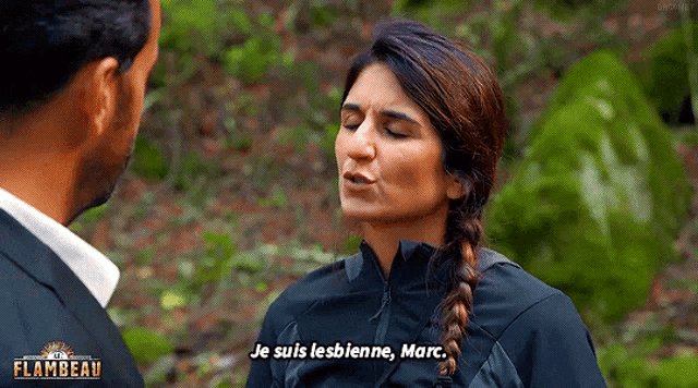 a woman in a black jacket is talking to a man and says je suis lesbienne marc