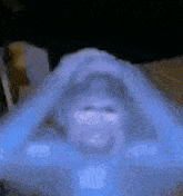 a blurry picture of a person 's face with a blue background and a shirt that says nike