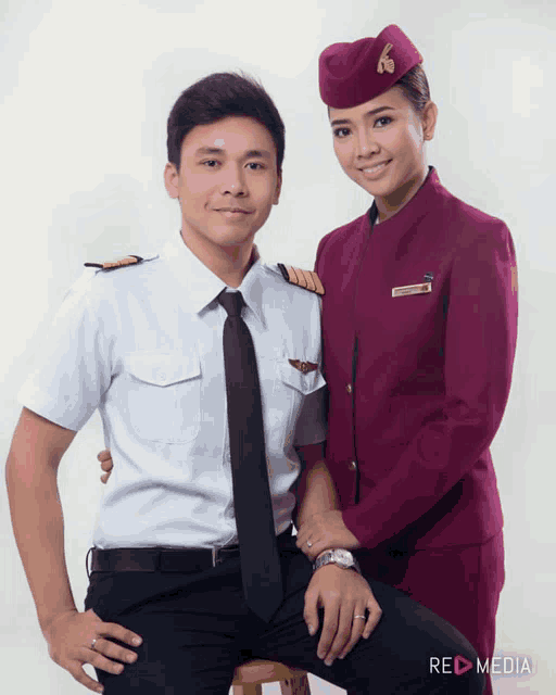 a man in a pilot uniform and a woman in a flight attendant uniform pose for a photo