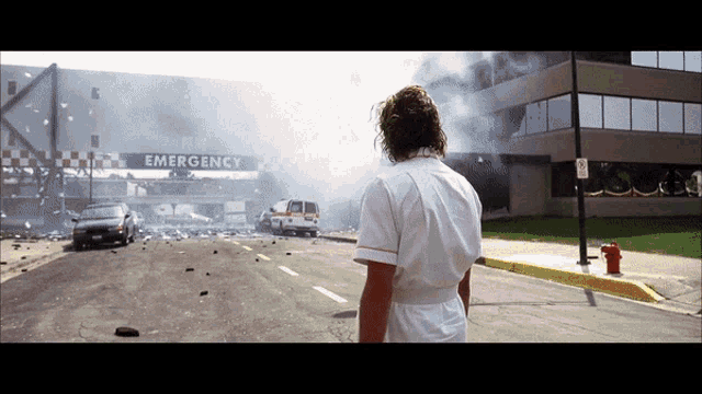 a man stands in front of an emergency entrance