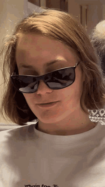 a woman wearing sunglasses is wearing a white shirt that says run too far