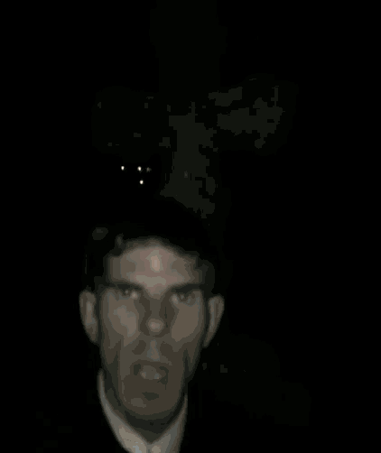 a close up of a man 's face with a red nose