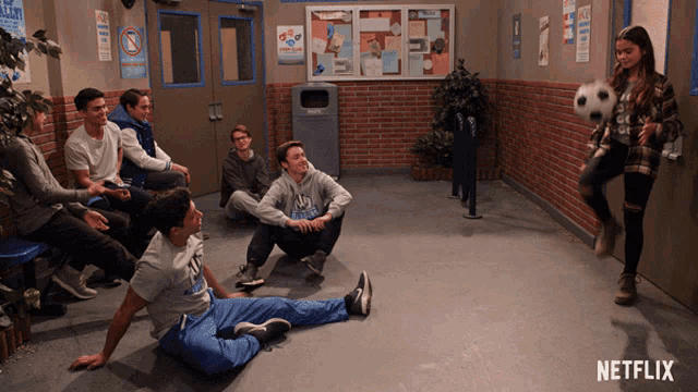 a girl kicking a soccer ball in a hallway with netflix written on the bottom