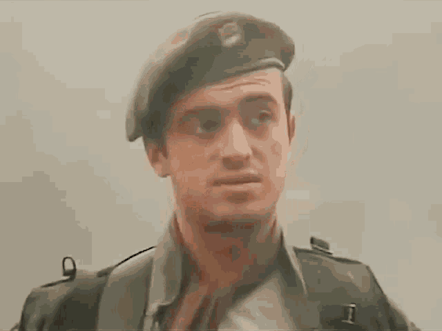 a man in a military uniform with the letter i on his belt