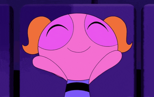 bubbles from the powerpuff girls is smiling while sitting in a theater seat