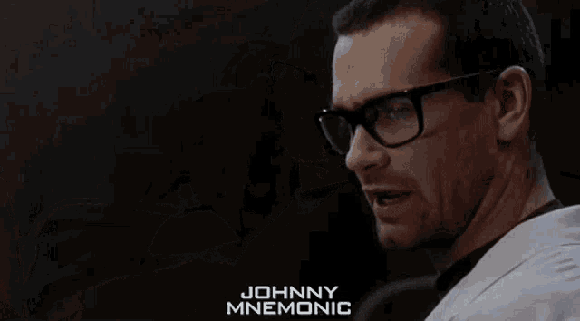 a man is laying in a hospital bed and the name johnny mnemonic is on the bottom