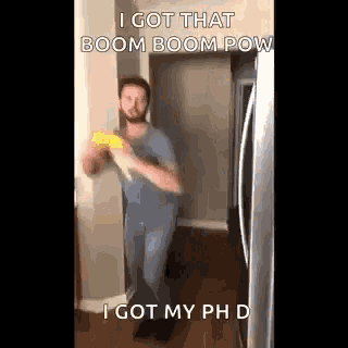 a man is holding a corn on the cob in a hallway .