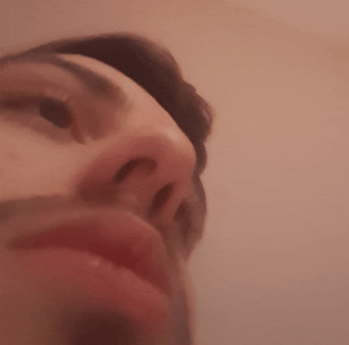 a close up of a person 's face with a beard